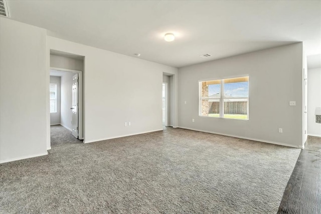 9912 Ruger Rd, Yukon, OK 73099 - carpeted empty room featuring plenty of natural light and baseboards