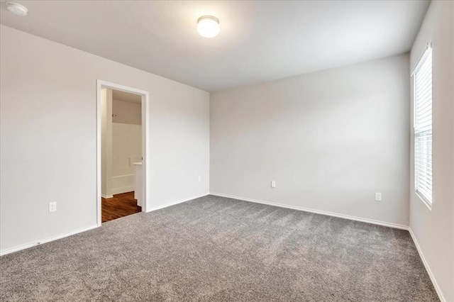 9912 Ruger Rd, Yukon, OK 73099 - unfurnished room featuring dark colored carpet, a smoke detector, and baseboards
