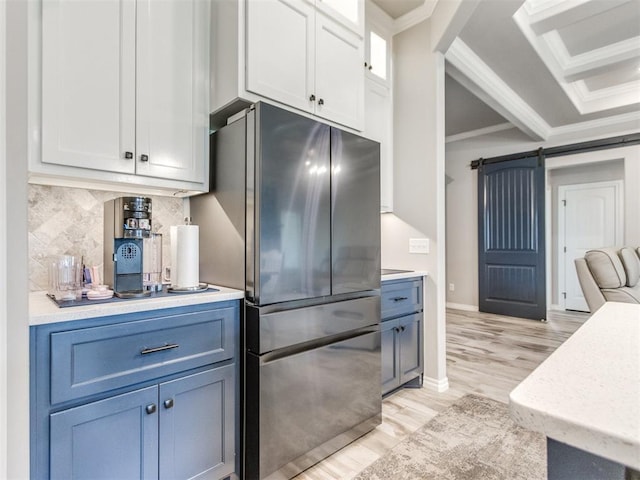 3317 Open Prairie Trl, Yukon, OK 73099 - kitchen featuring freestanding refrigerator, a barn door, crown molding, light countertops, and light wood finished floors