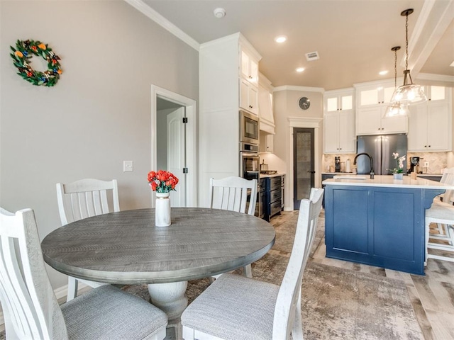3317 Open Prairie Trl, Yukon, OK 73099 - dining area featuring ornamental molding, light wood-type flooring, and recessed lighting