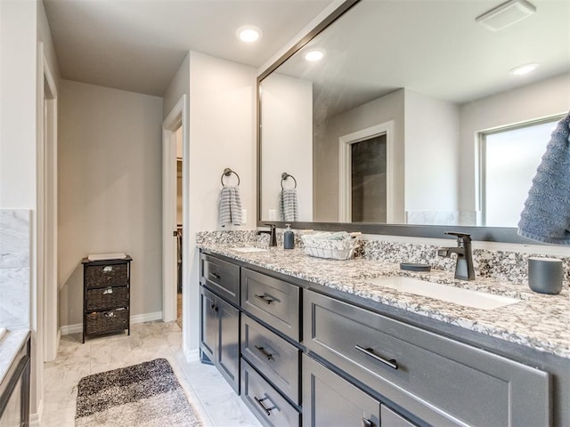 3317 Open Prairie Trl, Yukon, OK 73099 - full bathroom with double vanity, marble finish floors, and baseboards