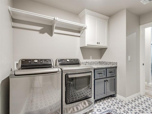 3317 Open Prairie Trl, Yukon, OK 73099 - washroom with cabinet space, washer and clothes dryer, baseboards, and light floors