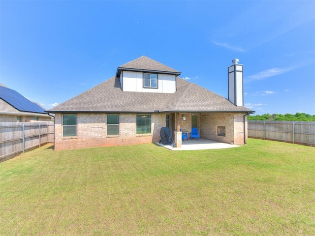 3317 Open Prairie Trl, Yukon, OK 73099 - rear view of house featuring a patio area, brick siding, a shingled roof, and a chimney