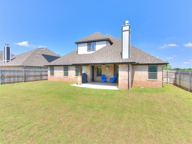 3317 Open Prairie Trl, Yukon, OK 73099 - back of house with a patio, roof with shingles, a chimney, and brick siding