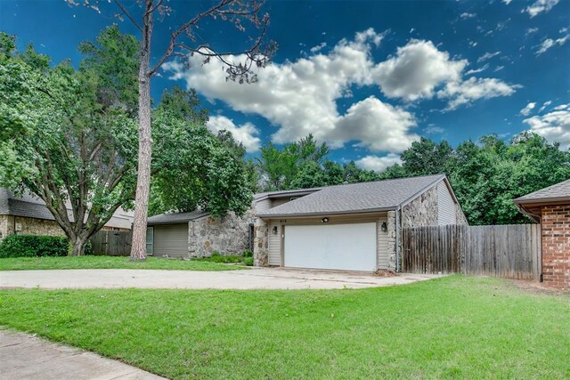 816 Woodbury Dr, Edmond, OK 73034 - view of front of house with driveway, a garage, and stone siding