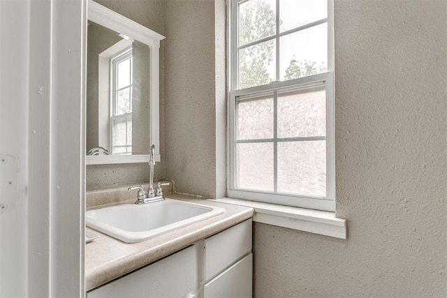 816 Woodbury Dr, Edmond, OK 73034 - bathroom with vanity and a textured wall