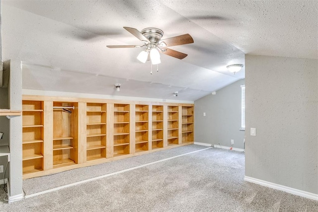 816 Woodbury Dr, Edmond, OK 73034 - carpeted empty room featuring a ceiling fan, a textured ceiling, lofted ceiling, and a textured wall