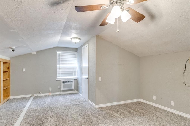 816 Woodbury Dr, Edmond, OK 73034 - bonus room with a textured ceiling, vaulted ceiling, carpet flooring, an AC wall unit, and a ceiling fan