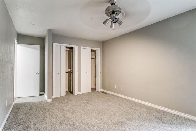 816 Woodbury Dr, Edmond, OK 73034 - unfurnished bedroom featuring carpet floors, two closets, and a ceiling fan
