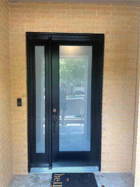 23 NE 3rd St, Oklahoma City, OK 73104 - view of exterior entry with brick siding and french doors
