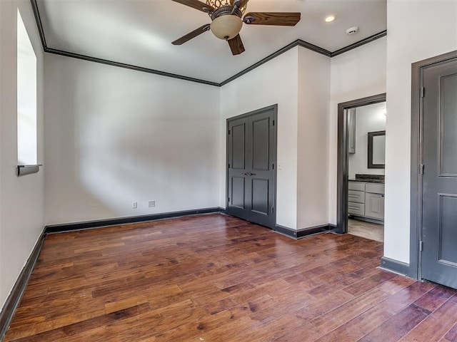 23 NE 3rd St, Oklahoma City, OK 73104 - unfurnished bedroom featuring ornamental molding, wood finished floors, baseboards, connected bathroom, and ceiling fan