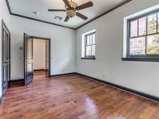 23 NE 3rd St, Oklahoma City, OK 73104 - unfurnished bedroom with ornamental molding, wood finished floors, baseboards, and ceiling fan