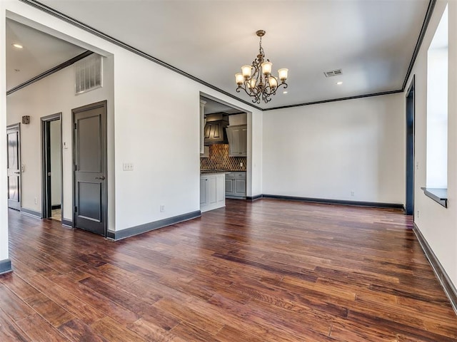 23 NE 3rd St, Oklahoma City, OK 73104 - empty room with a chandelier, ornamental molding, baseboards, dark wood-style floors, and recessed lighting