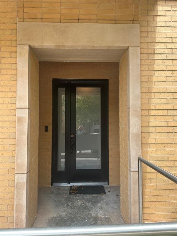 23 NE 3rd St, Oklahoma City, OK 73104 - doorway to property featuring brick siding