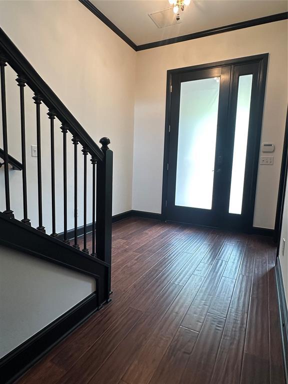 23 NE 3rd St, Oklahoma City, OK 73104 - foyer entrance featuring stairway, crown molding, dark wood-type flooring, and baseboards