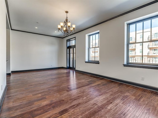23 NE 3rd St, Oklahoma City, OK 73104 - empty room featuring a chandelier, wood finished floors, ornamental molding, baseboards, and recessed lighting