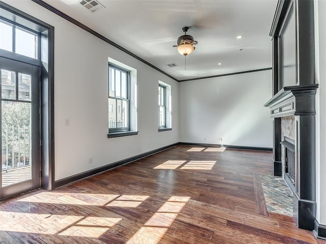 23 NE 3rd St, Oklahoma City, OK 73104 - unfurnished living room featuring ornamental molding, wood finished floors, baseboards, a fireplace with flush hearth, and recessed lighting