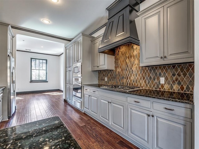 23 NE 3rd St, Oklahoma City, OK 73104 - kitchen featuring appliances with stainless steel finishes, custom exhaust hood, baseboards, dark wood finished floors, and a warming drawer