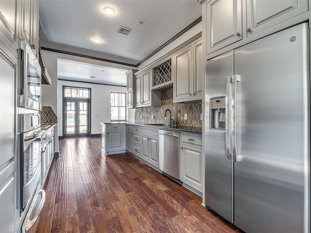 23 NE 3rd St, Oklahoma City, OK 73104 - kitchen with stainless steel appliances, gray cabinetry, a sink, dark wood finished floors, and decorative backsplash