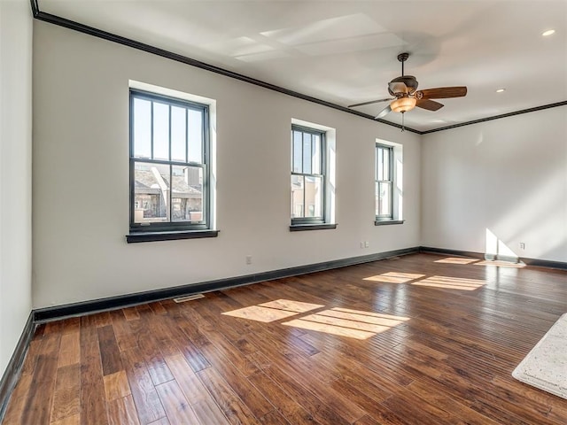 23 NE 3rd St, Oklahoma City, OK 73104 - spare room with ornamental molding, healthy amount of natural light, baseboards, dark wood-type flooring, and ceiling fan