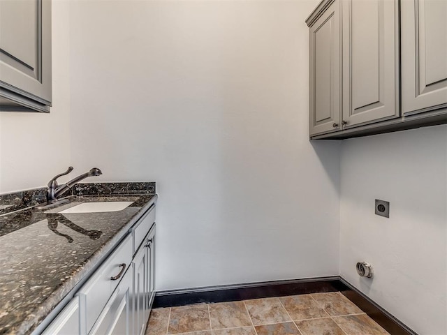 23 NE 3rd St, Oklahoma City, OK 73104 - washroom featuring hookup for an electric dryer, cabinet space, and baseboards
