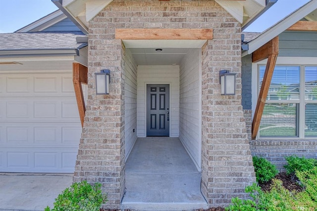 3232 Pagoda Pead Dr, Yukon, OK 73099 - view of exterior entry featuring an attached garage and brick siding