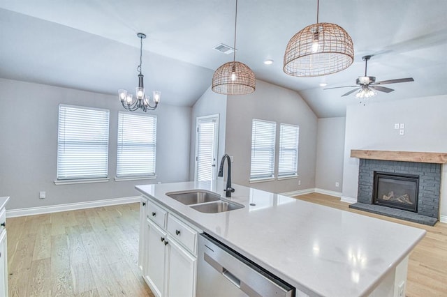 3232 Pagoda Pead Dr, Yukon, OK 73099 - kitchen with stainless steel dishwasher, light wood-style floors, ceiling fan, lofted ceiling, and white cabinetry