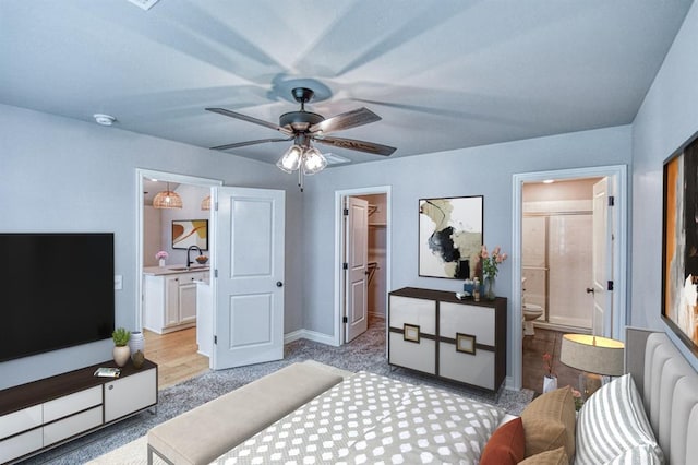 3232 Pagoda Pead Dr, Yukon, OK 73099 - bedroom with a spacious closet, connected bathroom, a closet, radiator heating unit, and ceiling fan