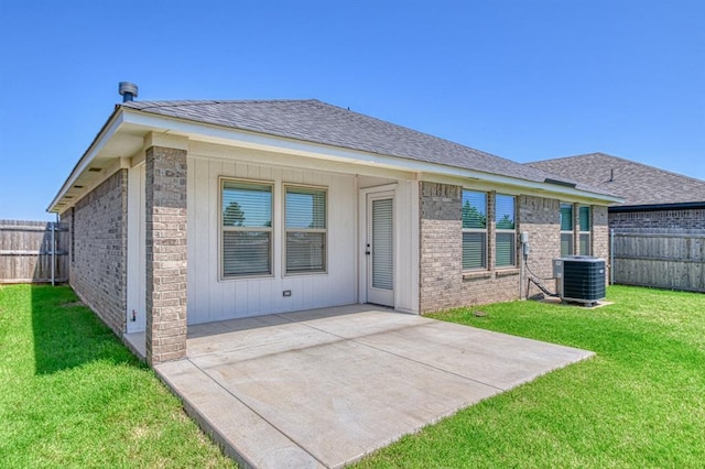3232 Pagoda Pead Dr, Yukon, OK 73099 - rear view of house with a fenced backyard, a patio area, a shingled roof, and brick siding