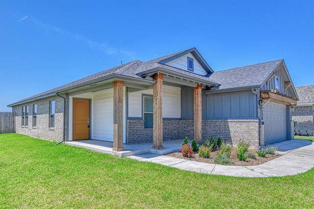 11100 NW 131st St, Yukon, OK 73099 - view of front of house featuring brick siding, board and batten siding, a garage, and roof with shingles