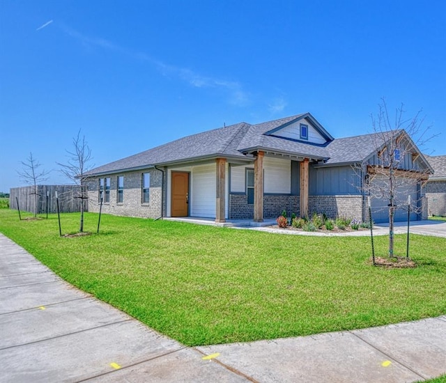 11100 NW 131st St, Yukon, OK 73099 - view of front of home featuring brick siding, concrete driveway, a garage, board and batten siding, and a shingled roof
