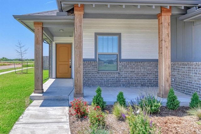 11100 NW 131st St, Yukon, OK 73099 - doorway to property featuring a yard and a porch