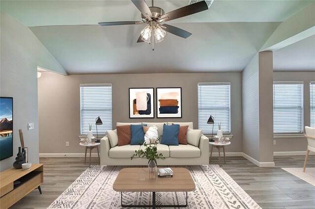 11100 NW 131st St, Yukon, OK 73099 - living room with baseboards, lofted ceiling, light wood finished floors, and plenty of natural light