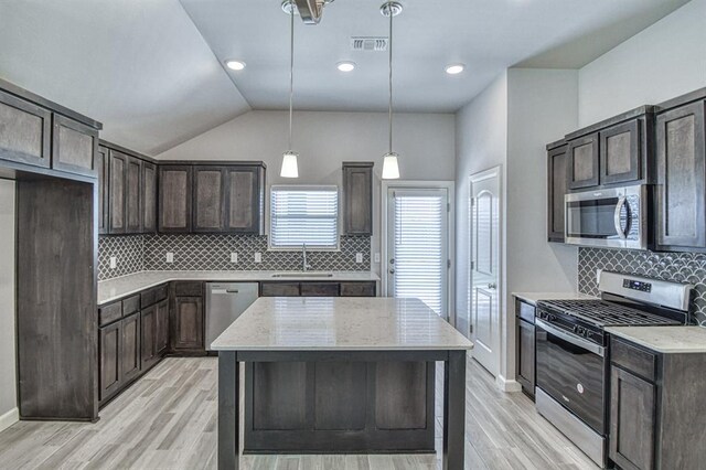 11100 NW 131st St, Yukon, OK 73099 - kitchen with stainless steel appliances, a sink, dark brown cabinetry, light wood-style flooring, and vaulted ceiling