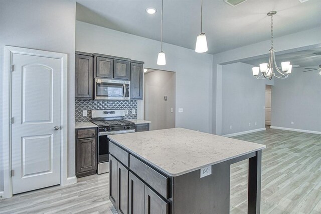 11100 NW 131st St, Yukon, OK 73099 - kitchen with stainless steel appliances, light wood-style flooring, baseboards, tasteful backsplash, and a center island