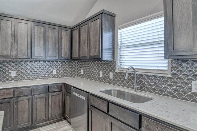 11100 NW 131st St, Yukon, OK 73099 - kitchen featuring stainless steel dishwasher, a sink, vaulted ceiling, light stone counters, and decorative backsplash