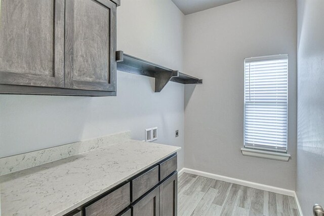 11100 NW 131st St, Yukon, OK 73099 - washroom with light wood-style floors, healthy amount of natural light, hookup for a washing machine, and cabinet space
