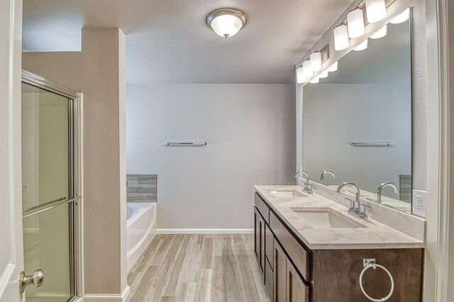 11100 NW 131st St, Yukon, OK 73099 - bathroom featuring wood finished floors, a garden tub, an enclosed shower, and double vanity