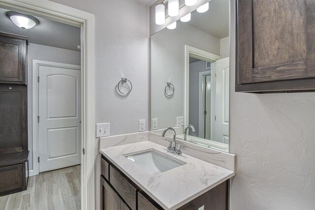 11100 NW 131st St, Yukon, OK 73099 - bathroom featuring vanity and wood finished floors