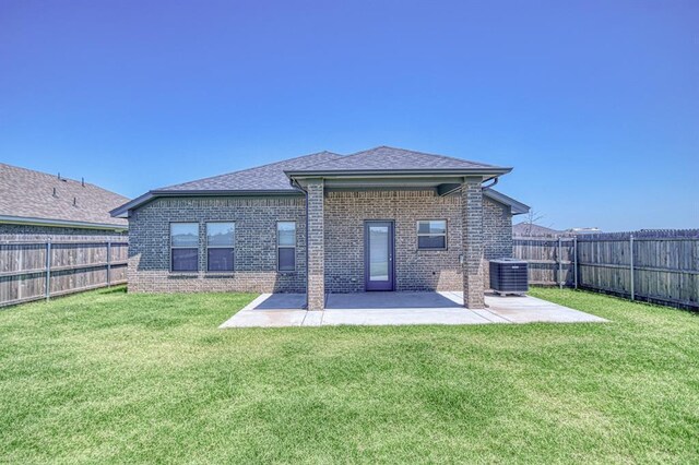11100 NW 131st St, Yukon, OK 73099 - back of property featuring central AC, brick siding, a patio, and roof with shingles