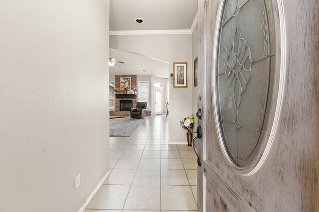 3401 First Capitol Cir, Guthrie, OK 73044 - foyer featuring light tile patterned floors, a fireplace, crown molding, baseboards, and a ceiling fan