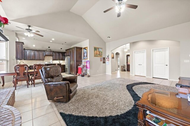 3401 First Capitol Cir, Guthrie, OK 73044 - living room featuring a ceiling fan, arched walkways, light tile patterned floors, high vaulted ceiling, and baseboards