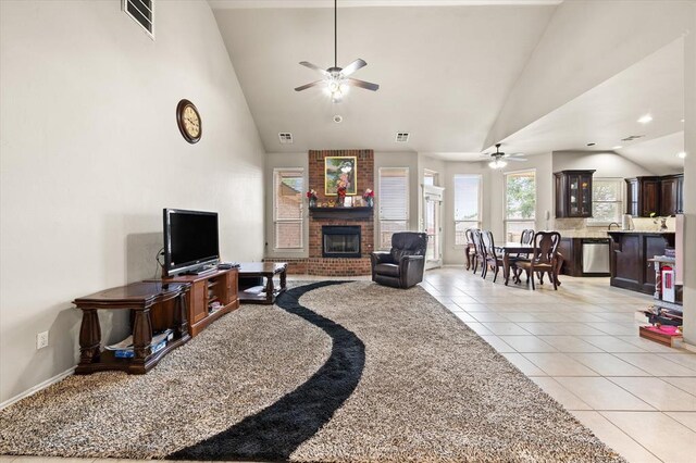 3401 First Capitol Cir, Guthrie, OK 73044 - living room with a ceiling fan, light tile patterned floors, a fireplace, high vaulted ceiling, and baseboards
