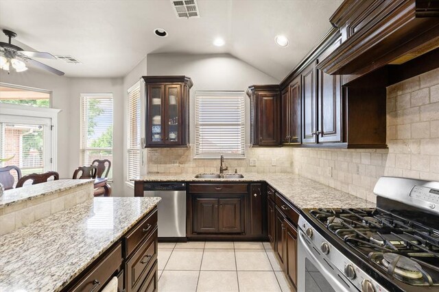 3401 First Capitol Cir, Guthrie, OK 73044 - kitchen with appliances with stainless steel finishes, a sink, a ceiling fan, dark brown cabinets, and backsplash