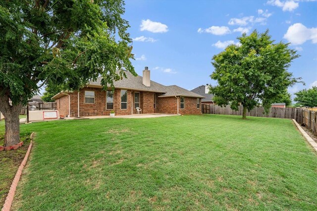3401 First Capitol Cir, Guthrie, OK 73044 - back of property featuring a patio, brick siding, and a chimney