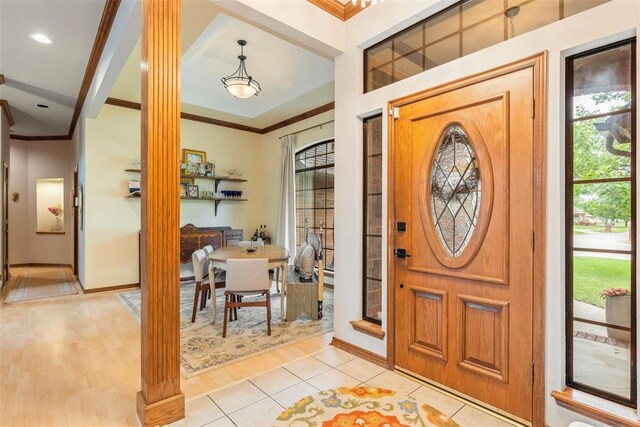 4001 Innsbrook Ct, Norman, OK 73072 - entrance foyer featuring ornamental molding, ornate columns, and light wood-style floors