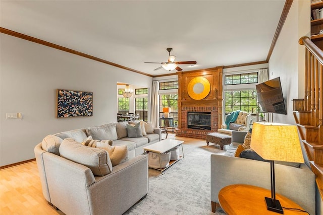 4001 Innsbrook Ct, Norman, OK 73072 - living area with crown molding, a ceiling fan, light wood finished floors, and a brick fireplace