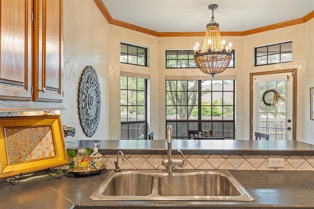 4001 Innsbrook Ct, Norman, OK 73072 - kitchen with dark countertops, a chandelier, crown molding, and decorative light fixtures