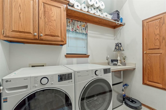 4001 Innsbrook Ct, Norman, OK 73072 - laundry area featuring independent washer and dryer, cabinet space, and tile patterned flooring