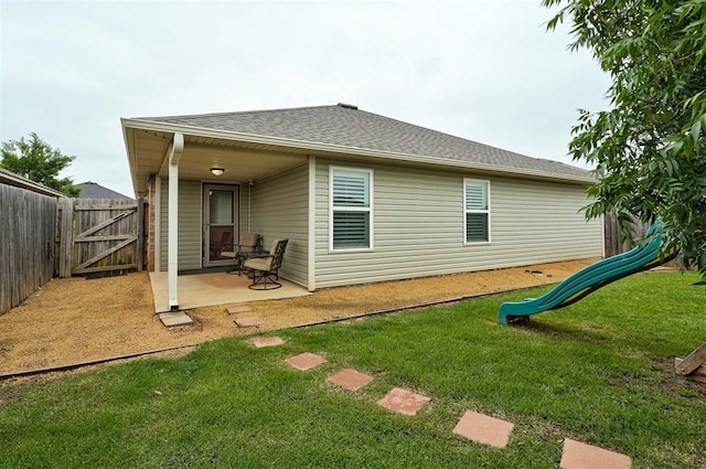 11513 SW 26th St, Yukon, OK 73099 - rear view of property featuring a patio, a gate, a shingled roof, and a playground